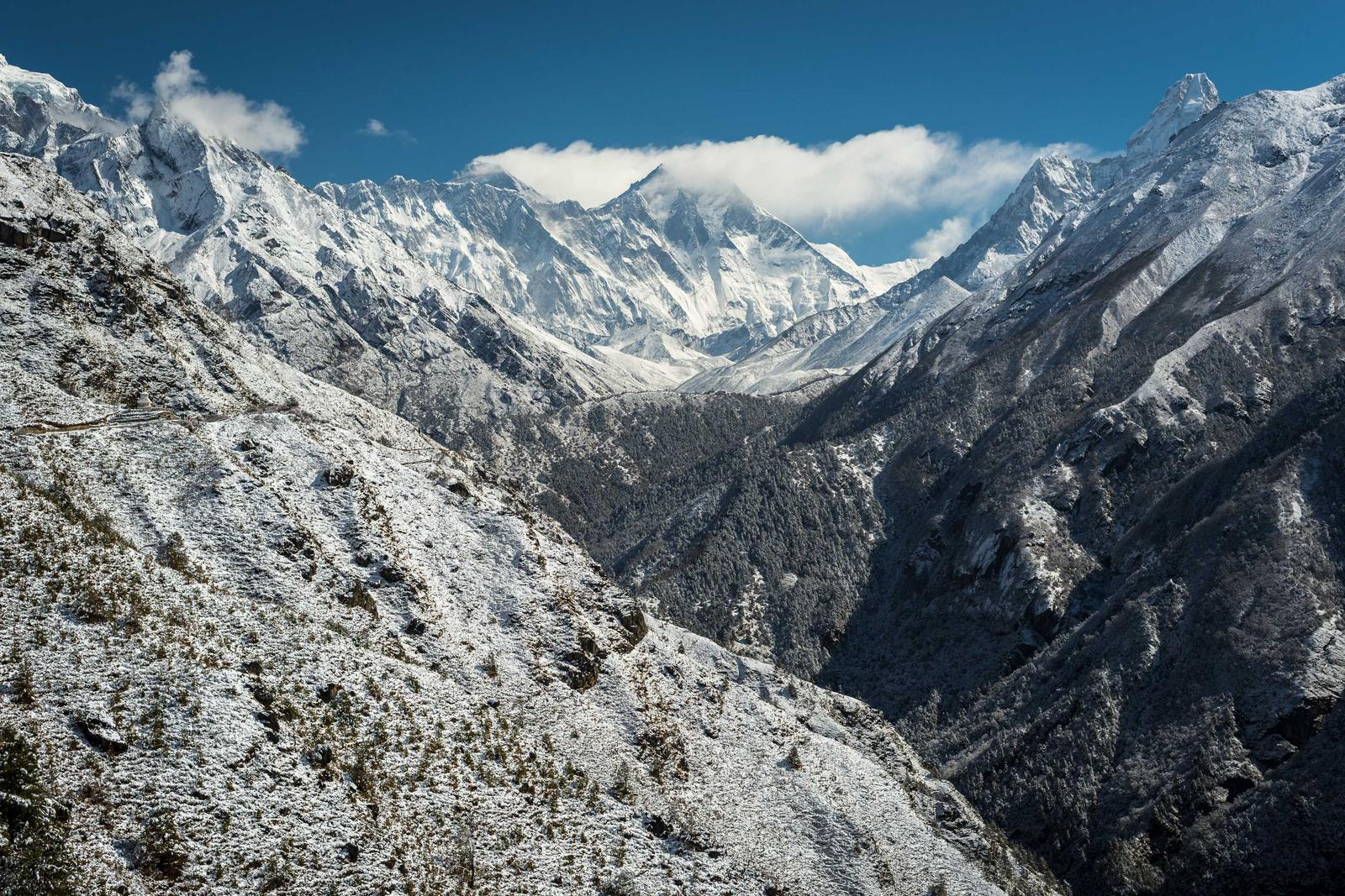 Snow-dusted alpine ridgeline under a clear sky